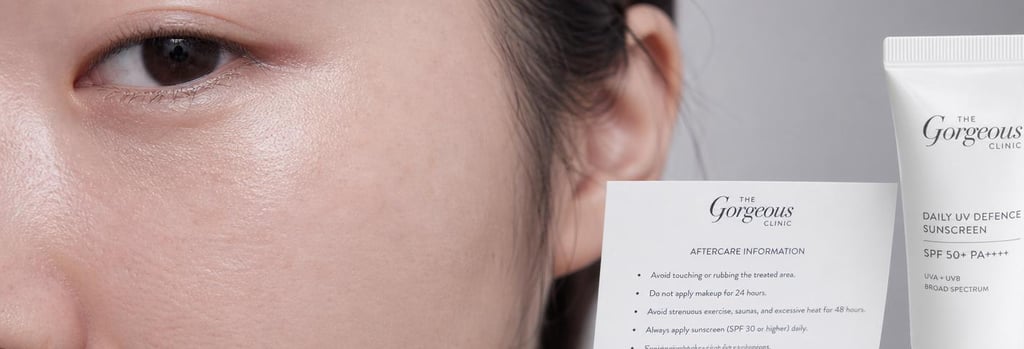 Photorealistic close-up of a Chinese woman's cheek and under-eye area, showing realistic skin texture, soft clinical lighting, a small aftercare information card and sunscreen tube visible, negative space for layout, calm editorial feel.